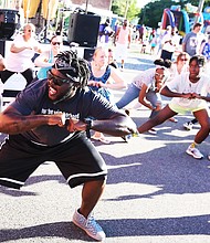 'In the Sun Again'/
Me’Kel Williams leads a cardio hip-hop session during the Robinson Theater Community Arts Center’s “In The Sun Again Community Block Party” last Friday at the Church Hill center. Mr. Williams demonstrated the workout he leads weekly at the center, where he is assistant director.  The block party continues the theater’s efforts to be a place that creates connections between residents and supports diversity and inclusion. (Regina H. Boone/Richmond Free Press)