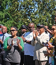 Honorary street sign for Fire Chief -Ronald C. Lewis
Leslie A. Lewis, foreground, celebrates the unveiling and dedication of an honorary street sign honoring her late husband, former Richmond Fire Chief Ronald C. Lewis. Dozens of friends, neighbors, firefighters and supporters turned out for the sign’s unveiling last Saturday at the intersection of Birdwood and Bathgate roads in South Side’s Brookbury neighborhood, where the Lewis family lives. The trailblazing Chief Lewis was Richmond’s first African-American fire chief, serving in the top position from 1978 to 1995. (Sandra Sellars/Richmond Free Press)