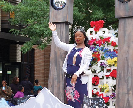 Rose Festival Queen Mya Brazile greets members of her community.