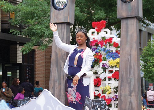 Rose Festival Queen Mya Brazile greets members of her community.