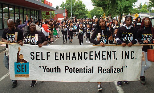 Students from Self Enhancement, Inc. march in Saturday’s parade.