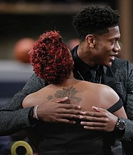 De’Andre Hunter of the University of Virginia gets a hug June 20 after being selected by the Los Angeles Lakers as the No. 4 pick in the NBA Draft in New York.