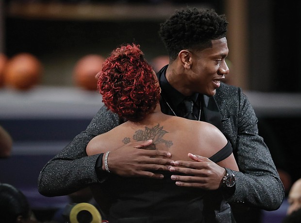 De’Andre Hunter of the University of Virginia gets a hug June 20 after being selected by the Los Angeles Lakers as the No. 4 pick in the NBA Draft in New York.