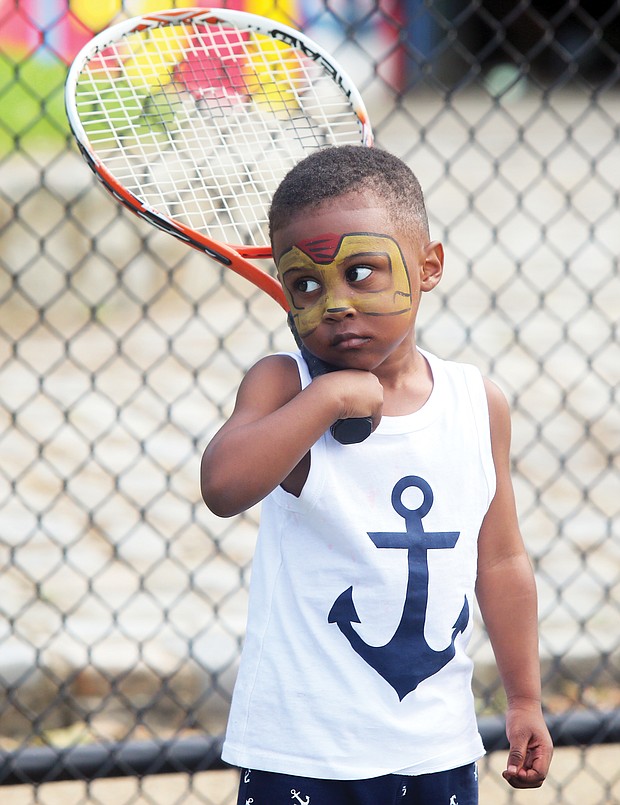 New to the game/
Darien Threatts, 2, channels his inner Ashe during a tennis skills session for children last Saturday at Battery Park in North Side. Friends of Battery Park collaborated with several other groups to put on the celebration at the park’s Arthur Ashe Tennis Courts. (Regina H. Boone/Richmond Free Press)