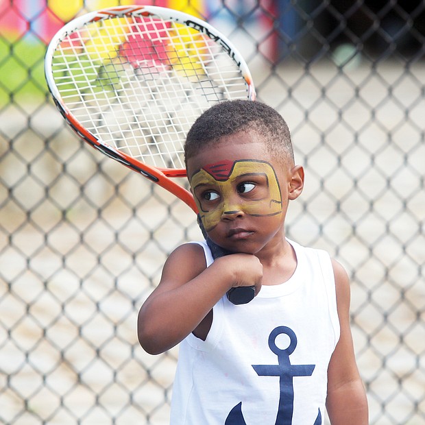 New to the game/
Darien Threatts, 2, channels his inner Ashe during a tennis skills session for children last Saturday at Battery Park in North Side. Friends of Battery Park collaborated with several other groups to put on the celebration at the park’s Arthur Ashe Tennis Courts. (Regina H. Boone/Richmond Free Press)