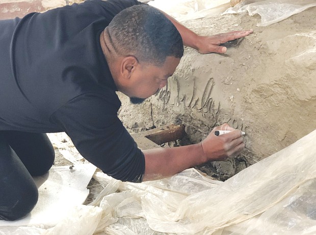 Kehinde Wiley signs his “Rumors of War” sculpture created in response to Confederate statues on Monument Avenue. The Wiley sculpture, which was acquired last week by the Virginia Museum of Fine Arts, will debut Sept. 27 in New York City’s Times Square before being moved in December to its permanent home outside the Richmond museum on Arthur Ashe Boulevard.