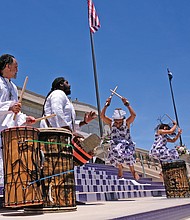 Members of the Elegba Folklore Society perform during the dedication ceremony, with founder Janine Bell explaining to the crowd how the sound of the drums open the road — the new Arthur Ashe Boulevard — “to let the people come forward.” (Sandra Sellars/Richmond Free Press)