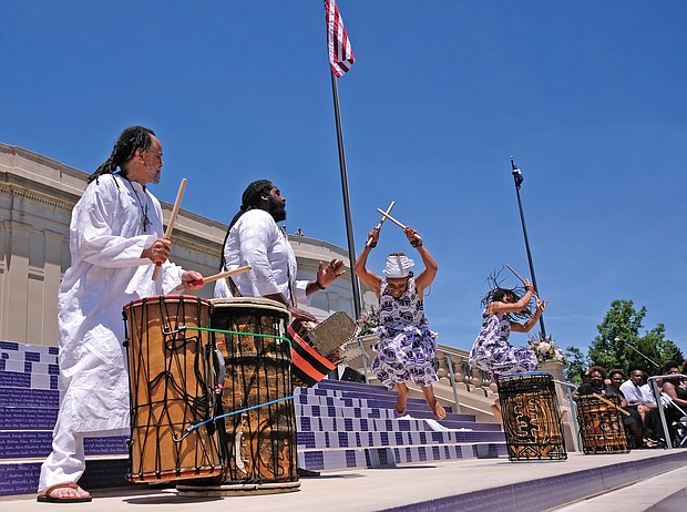 Members of the Elegba Folklore Society perform during the dedication ceremony, with founder Janine Bell explaining to the crowd how the sound of the drums open the road — the new Arthur Ashe Boulevard — “to let the people come forward.” (Sandra Sellars/Richmond Free Press)