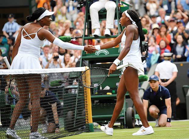 Cori Gauff, 15, receives a congratulatory handshake from her 39-year-old opponent Venus Williams after the teen beat the tennis champion 6-4, 6-4 Monday at Wimbledon. Gauff’s next match is Wednesday.