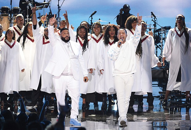 DJ Khaled and John Legend stand in front of a choir to lead a musical tribute to Nipsey Hussle during the BET Awards on June 23 at Microsoft Theater in Los Angeles.