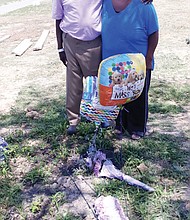 Bobby L. Stith and his mother, Rose M. Stith, visit the grave of family member Byron M. Stith Jr. at Oakwood Cemetery on June 27.
