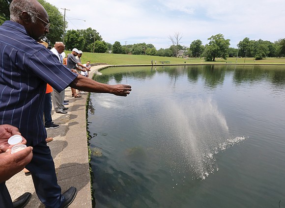 Greg Roland and other comrades of George Edward “Buster” Booth scatter his ashes May 29 in Byrd Park’s Swan Lake ...