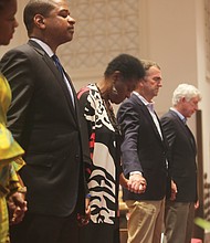 From left, Lt. Gov. Justin E. Fairfax, Richmond Delegate Delores L. McQuinn, Gov. Ralph S. Northam and Attorney General Mark R. Herring pray during a “Stop the Gun Violence Rally” last Sunday at Thirty-first Street Baptist Church in the East End. Delegate McQuinn organized the event ahead of Tuesday’s special legislative session.