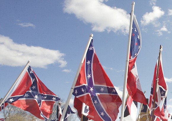 About a dozen people wearing white Klan robes and waving Confederate flags held a recruitment rally last Saturday outside the ...