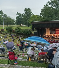 Fourth of July fans
Rain couldn’t dampen the Fourth of July holiday spirit of spectators who donned rain gear and huddled under umbrellas to hear the Richmond Concert Band perform at Richmond’s Dogwood Dell. The annual performance ushered in a fireworks show despite stormy weather last Thursday that canceled other area events.(photo by Ava Reaves)