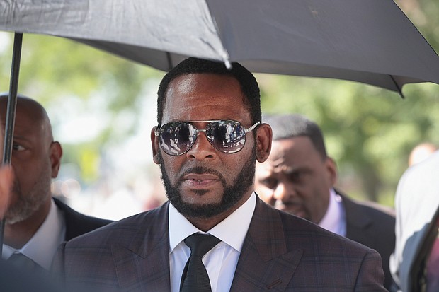 R. Kelly is charged with sex trafficking in New York and attempting to influence a case in Atlanta, and was arrested while walking his dog, a source with knowledge of the arrest said.