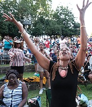 Pam Kearny joins in the praise as one of the hundreds of people attending the 10th Annual Gospel Music Festival on Sunday at Dogwood Dell. The free event was hosted by Sheilah Belle and Praise 104.7 FM as part of the City of Richmond’s Festival of Arts. (Sandra Sellars/Richmond Free Press)