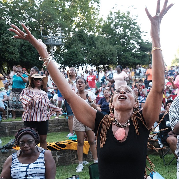 Pam Kearny joins in the praise as one of the hundreds of people attending the 10th Annual Gospel Music Festival on Sunday at Dogwood Dell. The free event was hosted by Sheilah Belle and Praise 104.7 FM as part of the City of Richmond’s Festival of Arts. (Sandra Sellars/Richmond Free Press)