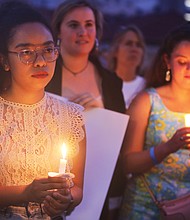 Adele McClure, left, holds a candle during last Friday’s “Lights for Liberty” vigil on the State Capitol grounds calling for an end to the detention camps and family separations imposed on migrants to the United States along the southern border. Hundreds of people attended the vigil, which was sponsored by numerous Richmond area organizations, including Indivisible Virginia, the Virginia ACLU, UndocuRams and ReEstablish Richmond. Local activists, advocates and others spoke at the event, which was one of nearly 700 Lights for Liberty events held around the globe. (Regina H. Boone/Richmond Free Press)