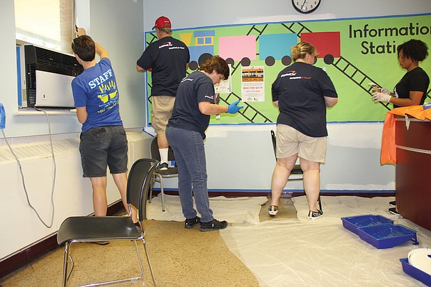 A team of Capital One volunteers from Richmond, Northern Virginia, Maryland, Delaware, New Jersey, New York, New Orleans and Texas put a fresh coat of paint on a new office for the principal at Fairfield Court Elementary School on Wednesday as a part of RPS Shines 2019.