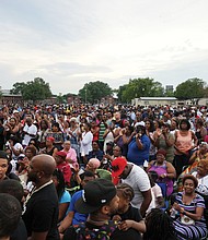 Hundreds of people gather in Norfolk’s Young Terrace public housing community Tuesday night to pay tribute to late boxing champion Pernell “Sweet Pea” Whitaker, who grew up in the neighborhood. Whitaker Lane, located about a block away from the vigil held on the grounds of P.B. Young Elementary School, had been named for the legendary boxer. Speakers included Norfolk Mayor Kenny Alexander, Norfolk Delegate Jay Jones and Virginia Beach City Councilman Aaron Rouse, a former NFL player.