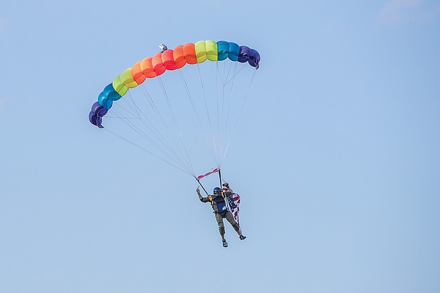 a sky diver parachutes onto the field at The Diamond before the game on July 10.