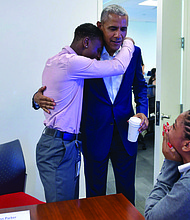President Obama hugs Aaron Park, a Youth Jobs Corps intern, during his surprise visit to the Obama Foundation Headquarters where he met with 13 students who, like Park, are also participating in the Youth Jobs Corps program. Photo Credit: The Obama Foundation