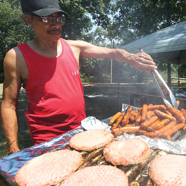 Black Pride RVA/
Sam Patterson, 62, handles the grill at last Saturday's Pride in the Park Tailgate Party, the final event of the 2nd Annual Black Pride RVA. The four-day festival was designed to promote the health and wellness of the black LGBTQ community through celebration, education and empowerment. (Regina H. Boone/Richmond Free Press)