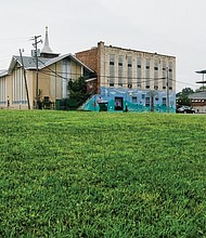 Looking toward Mount Olivet Church from 26th and R streets, the expansive lawn encompasses the tax-delinquent properties for which more than $72,000 is owed.