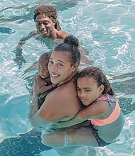 Beating the heat/
Kiana Robinson and Dashon Roberts Sr. enjoyed a family outing at the city’s Blackwell Pool in South Side. As Ms. Robinson holds her 5-month-old son, Dashon Jr., her 7-year-old daughter, Kayoloni, clings to her back. So far this month, temperatures have reached or exceeded the 90s for 18 days. After a short break in the mid- to upper 80s on Friday and Saturday, temperatures are expected to climb next week and hover again in the 90s. (photo by Ava Reaves)