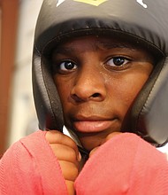 Shawn Brooks, 13, of Henrico takes a boxer’s stance during a recent weeklong boxing camp for young people at Cherry Pick’d Boxing & Fitness on North Side. The camp was sponsored by two nonprofits, Breaking Barriers and First Contractors Inc.