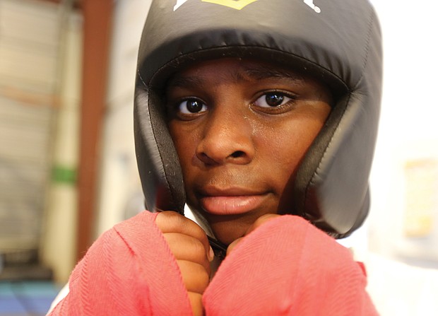 Shawn Brooks, 13, of Henrico takes a boxer’s stance during a recent weeklong boxing camp for young people at Cherry Pick’d Boxing & Fitness on North Side. The camp was sponsored by two nonprofits, Breaking Barriers and First Contractors Inc.
