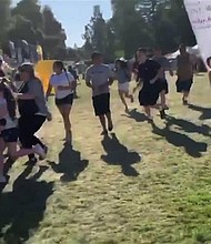 A screengrab taken from video and uploaded to twitter appears to show people scrambling at the Gilroy Garlic Festival.