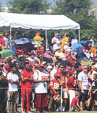 Hundreds of fans watch the Washington NFL team’s training session on Saturday. The training camp will continue, and be open to fans, through Aug. 11.