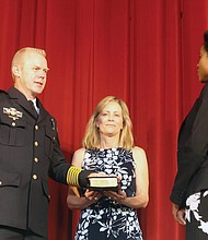 Richmond Police Chief Will Smith is sworn in as the city’s top cop during a ceremony Wednesday held at Virginia Union University’s Coburn Hall. The chief’s wife, Virginia “Ginnie” Smith, holds the Bible while City Clerk Candice Reid administers the oath. Chief Smith is the city’s 19th police chief. He
was joined at the ceremony by his two daughters, Mayor Levar M. Stoney, members of City Council and dozens of current and retired law enforcement officers from Richmond and around the state. (Regina H. Boone/Richmond Free Press)