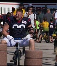 JJ Watt on a child's bike