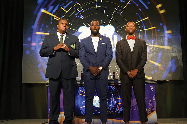 From left, Norfolk State University Coach Latrell Scott takes the stage at the recent MEAC banquet with linebacker Nigel Chavis and quarterback Juwan Carter.