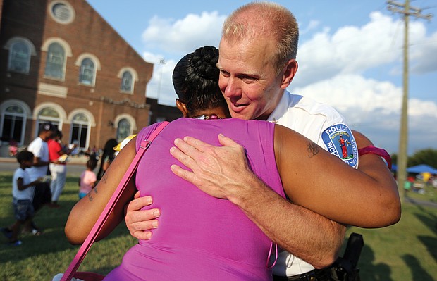 Chiquita Compton gives Richmond Police Chief Will Smith a big hug during his visit to the National Night Out festivities at Jackson Ward’s Sixth Mount Zion Baptist Church on Tuesday.