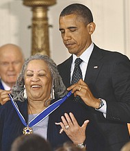 In 2012, President Obama awards a Presidential Medal of Freedom to prize-winning author Toni Morrison at the White House. The medal is the nation’s highest civilian honor.