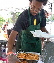 Marquis Smith serves up fish and fries at the 11th Annual St. Elizabeth Catholic Church Jazz & Food Festival. (Sandra Sellars/Richmond Free Press)