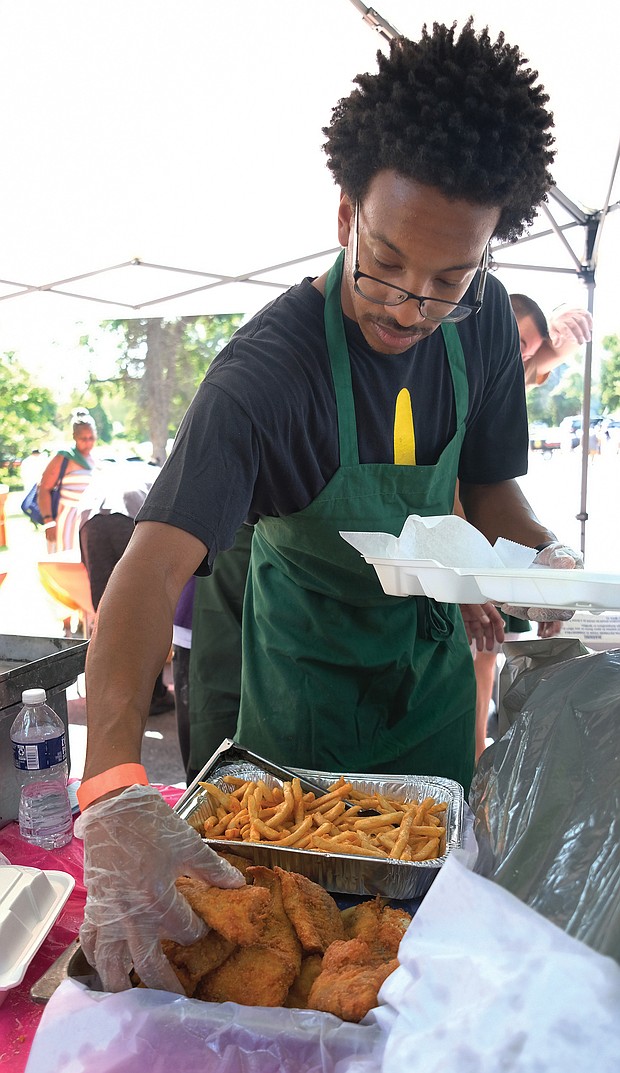 Marquis Smith serves up fish and fries at the 11th Annual St. Elizabeth Catholic Church Jazz & Food Festival. (Sandra Sellars/Richmond Free Press)