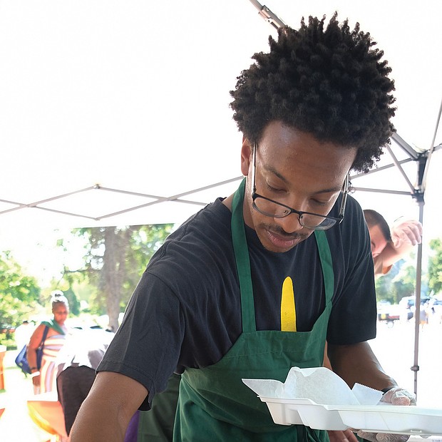 Marquis Smith serves up fish and fries at the 11th Annual St. Elizabeth Catholic Church Jazz & Food Festival. (Sandra Sellars/Richmond Free Press)