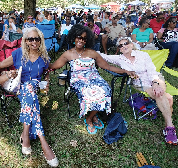 Music for the spirit. Hundreds turned out for the 11th Annual St. Elizabeth Catholic Church Jazz & Food Festival, a fundraiser held last Saturday for the Highland Park parish and its various ministries. Location: The park beside the church on 2nd Avenue. Friends, from left, S.R. Jeffers, Vanessa Raines and Diana Joaquin settle in to enjoy the sounds of local musicians, including the legendary Doc Branch and the Keynotes. (Sandra Sellars/Richmond Free Press)