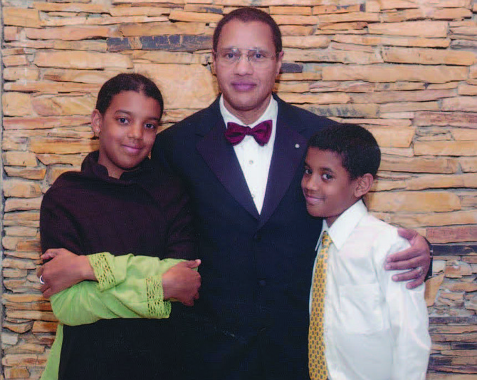 Dr. Carl Bell (middle) with his two children, Briatta (left) and William (right). Photo Credit: Provided by Tyra Taylor-Bell