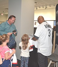 Young Fans of Baseball Hall of Famer Harold Baines signs autographs