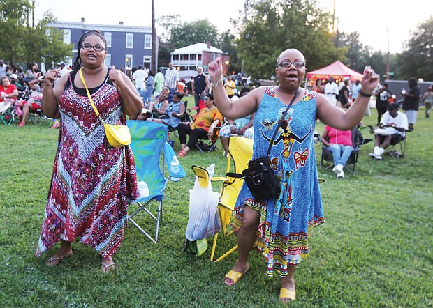 A ‘Down Home’ good time/
Music, food, entertainment and fun were the key ingredients last Saturday for the 29th Annual Down Home Family Reunion at Abner Clay Park in Jackson Ward. Hundreds of people turned out to enjoy the free event, hosted by the Elegba Folklore Society to celebrate African-American folk life. Sonya Eldridge and Andrena Graves are brought to their feet by the music. (Regina H. Boone/Richmond Free Press)