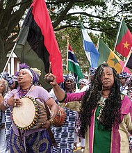 African-American dancers, drummers and flag bearers parade at Fort Monroe on Saturday following more than two hours of speeches. (photo by Ava Reaves)