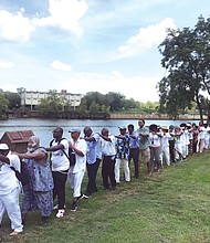 A line of people marches along a portion of the Richmond Slave Trail beside the James River on their way from the Old Manchester docks to Downtown. The walk on Aug. 20 was led by Janine Y. Bell of the Elegba Folklore Society and was symbolic of the many slave coffles in Richmond, which was one of the largest markets for the sale of enslaved people before the end of the Civil War. The walk was one element of the three-day Black Lives Global Summit that the Connecticut-based Community Healing Network sponsored. The summit, held largely at Virginia Union University in concert with other events related to the 400th anniversary of the forced arrival of the first Africans in English North America, focused on providing emotional and psychological healing from the lingering impact of slavery and included a range of speakers focusing on the past, present and future for people of African descent. (Regina H. Boone/Richmond Free Press)