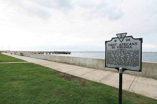 A state historial marker outlining the history of the “First Africans in Virginia” stands near the seawall at the Fort Monroe National Historic Site. The area was known as Point Comfort in 1619 when the “20 and odd Negroes,” captured by the Portugese in Africa and then stolen by pirates on the English ship White Lion, were traded in Virginia for food and provisions. (Regina H. Boone/Richmond Free Press)