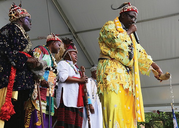 Water is poured from an animal horn during a traditional libation ceremony Saturday by representatives of various African nations. (Regina H. Boone/Richmond Free Press)